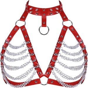 May include: Red leather harness with silver chain detailing. The harness features a choker-style collar with silver studs, connecting to the chest with a central ring. Silver chains hang from the chest straps, creating a layered effect. The harness is designed with multiple adjustable straps.