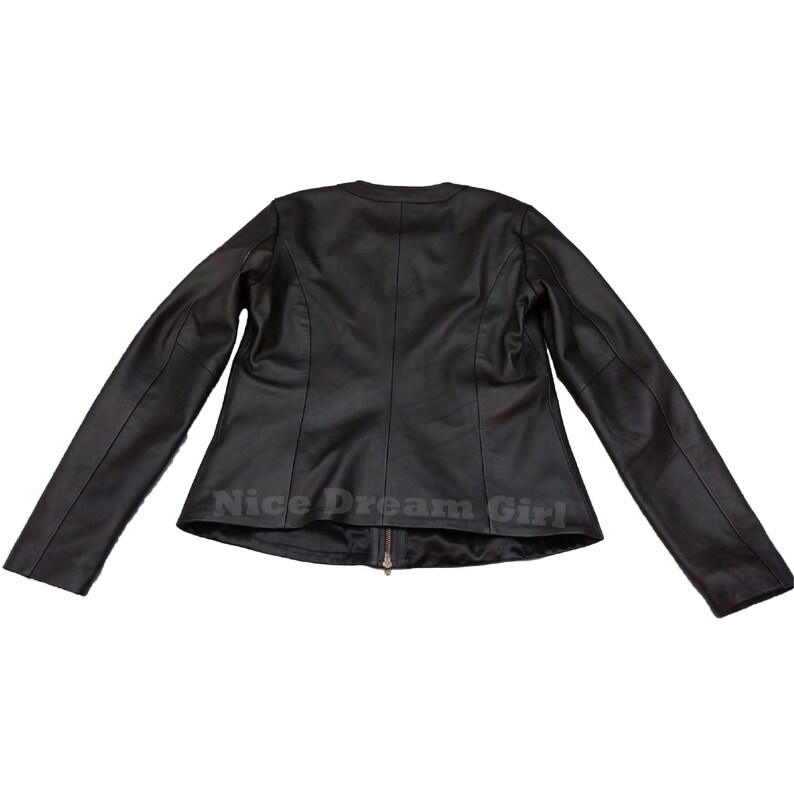 May include: A black leather jacket with a round collar and long sleeves. The jacket has a zipper closure and the text "Nice Dream Girl" is printed at the bottom. The jacket is displayed against a white background.