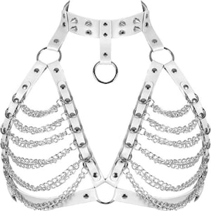 May include: White faux leather body harness with silver-tone metal chain and ring accents. The harness features a choker-style collar with studded details and adjustable straps. The design includes multiple rows of dangling chains.