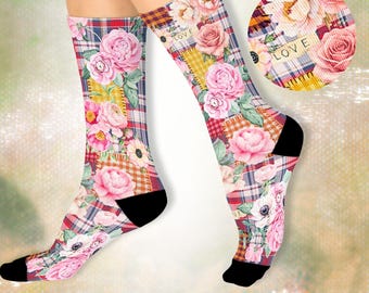 May include: A pair of crew socks featuring a plaid pattern in shades of blue, red, and yellow, overlaid with pink floral illustrations and the word LOVE printed on a small rectangular patch. The socks have solid black heels and toe sections.