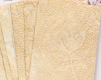 May include: A stack of rectangular paper sheets with a tea-stained appearance, featuring a light brown giraffe-like spot pattern and a prominent leaf silhouette design. The text "SAIDONIA Studio" is printed in the upper left corner of the paper.