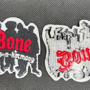 May include: Two embroidered patches. One patch features the words "Bone thugs-n-harmony" in red and white, with a black silhouette of people. The other patch says "Bous" in red.