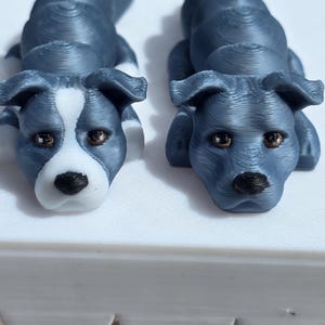 May include: A white ceramic mug with a black handle and the text "But First, Coffee" in a handwritten style. The mug is on a white surface. The mug is likely for hot beverages.