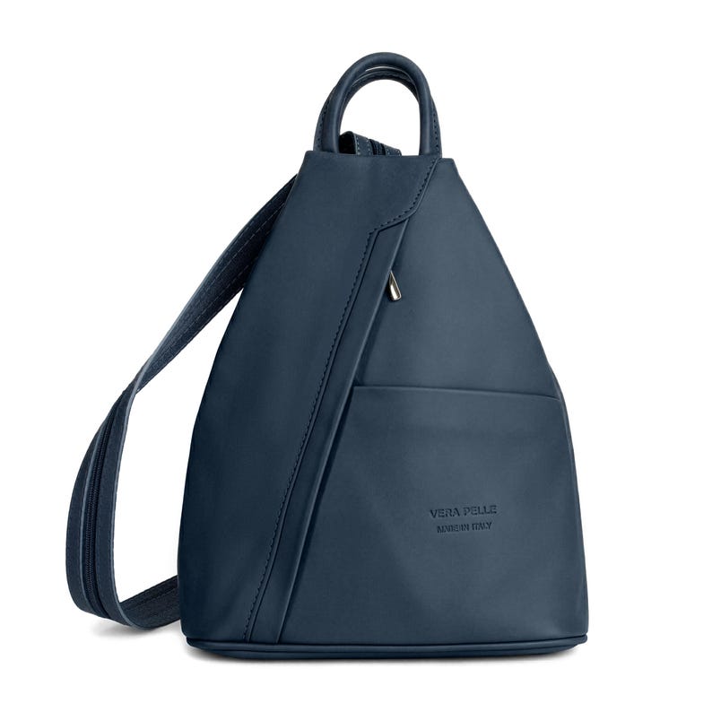 May include: A navy blue leather backpack with a triangular shape. The backpack has a top handle, adjustable straps, and a front pocket with a zipper. The text "VERA PELLE MADE IN ITALY" is embossed on the front.