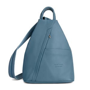 May include: A blue leather backpack with a top handle and adjustable shoulder straps. The bag has a front pocket and a zipper closure. The text "VERA PELLE MADE IN ITALY" is embossed on the front.
