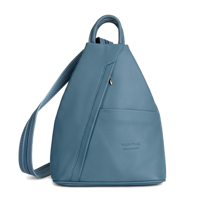 May include: A blue leather backpack with a top handle and adjustable shoulder straps. The bag has a front pocket and a zipper closure. The text "VERA PELLE MADE IN ITALY" is embossed on the front.
