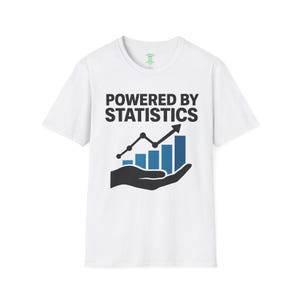 May include: A white short-sleeved t-shirt featuring the black text POWERED BY STATISTICS printed above a graphic of a black hand holding a blue bar chart with an upward-trending arrow. The design is centred on the chest of the garment.
