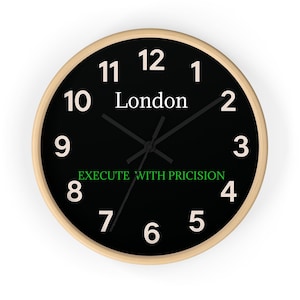 May include: A round wall clock with a light wood frame and a black face. The clock face features white numerals, the word "London", and the phrase "EXECUTE WITH PRICISION" in green. The clock hands are black.