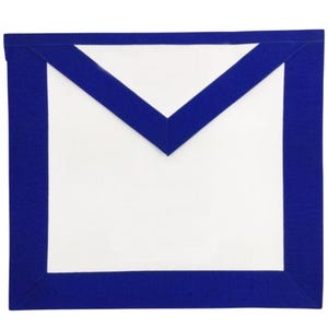 May include: A white apron with a blue border and a blue V-shaped design at the top. The apron is rectangular and made of a smooth fabric. The blue border is a darker shade than the blue V-shape. The apron is likely for ceremonial use.