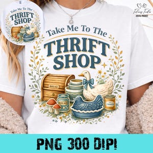 Pode incluir: Camiseta branca com um design gráfico colorido. O design apresenta o texto "Take Me To The THRIFT SHOP" em azul e dourado, juntamente com ilustrações de um pato, pão e outros itens vintage. A parte inferior da camiseta tem o texto "PNG 300 DIPI".