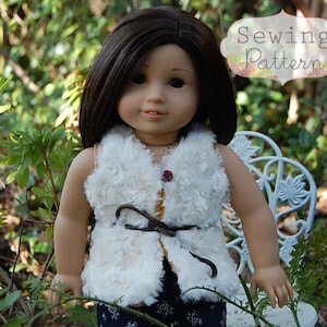 May include: A white faux fur vest with a brown leather belt and a button closure. The vest is being worn by a doll with long brown hair.