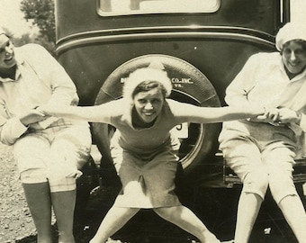 Woman Being Pulled In Two Directions by GIRLFRIENDS in Fun 1930s Photo