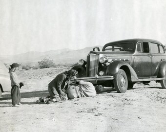 Little Girl Looks On As PARENTS Try To Fix Broken Down Car in Middle of Desert 1940s Photo