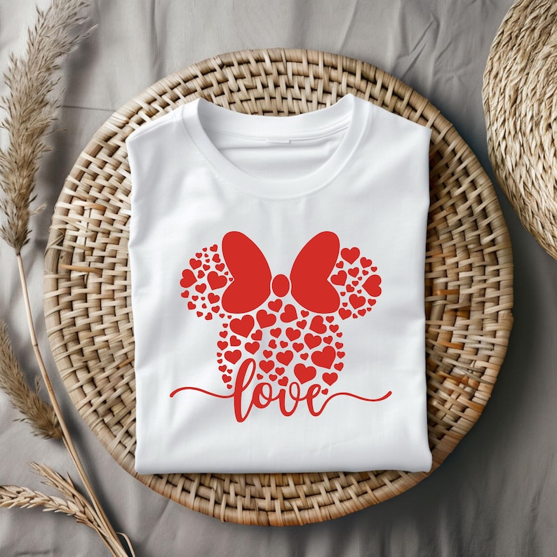 May include: White t-shirt with a red heart-shaped Mickey Mouse head design and the word "love" written in cursive below.