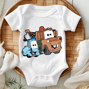 May include: White baby grow with a cartoon image of tow truck Mater and a blue car from the Disney Pixar movie Cars.