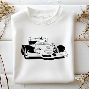 May include: A white sweatshirt featuring a black and white illustration of a cartoon race car driver. The driver is wearing a helmet and goggles and has a big smile. The car is a Formula One race car with a large wing at the back.