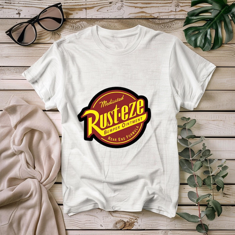 May include: White t-shirt featuring a red and yellow logo that reads "Medicated Rust-eze Bumper Ointment Rear End Formula".