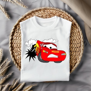 May include: White t-shirt featuring a red cartoon car with the text "Rust-eze" on the side. The car is driving through a cloud of smoke and has a surprised expression on its face.