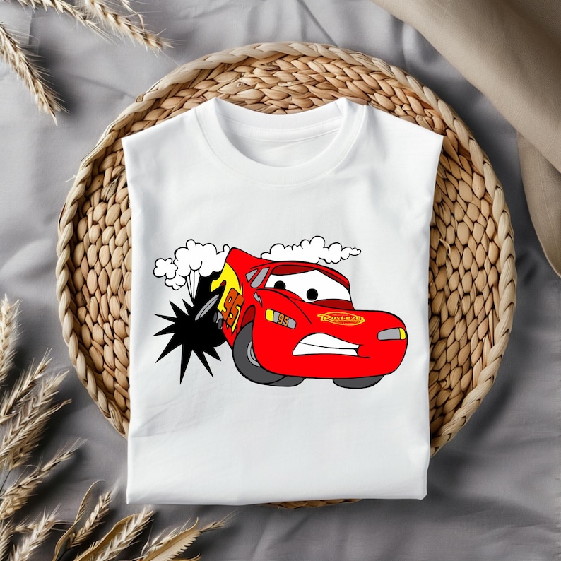 May include: White t-shirt featuring a red cartoon car with the text "Rust-eze" on the side. The car is driving through a cloud of smoke and has a surprised expression on its face.