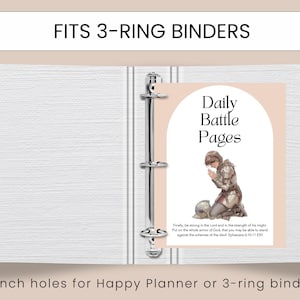 May include: A white 3-ring binder with a Daily Battle Pages insert. The insert features an illustration of a person in armor kneeling in prayer. Text at the top reads "FITS 3-RING BINDERS".