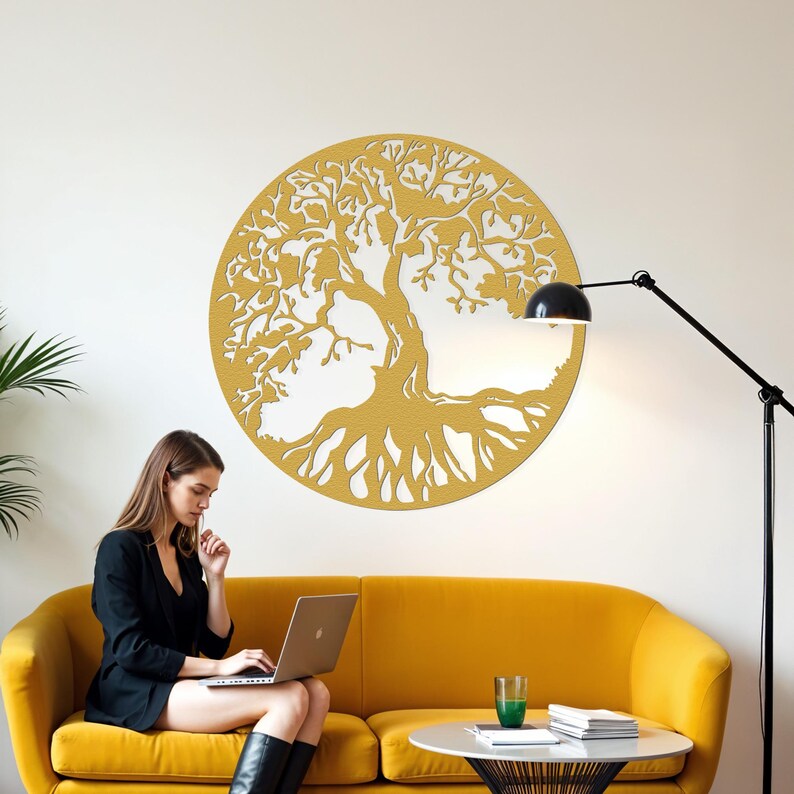 May include: A yellow wooden tree of life wall decor with intricate branches and roots. The decor is hanging on a white wall in a living room setting with a yellow couch and a lamp.