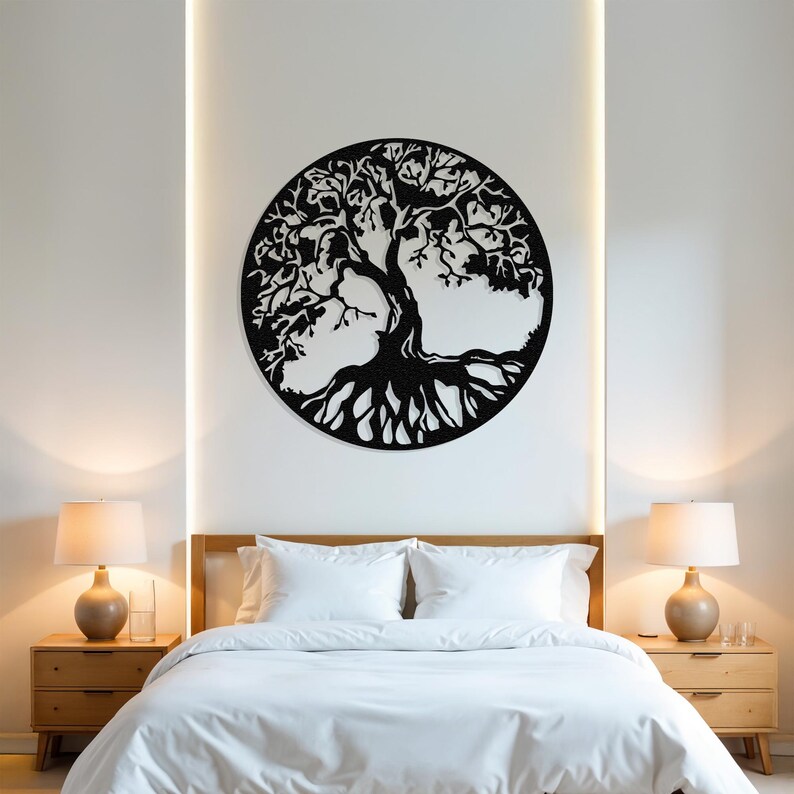 May include: A black metal tree of life wall decor with intricate branches and roots, hanging on a white wall above a white bed with white bedding and two bedside tables with lamps.