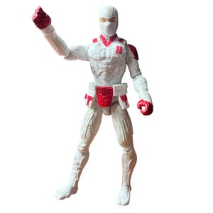 May include: A white and red action figure featuring a masked head, a textured suit with molded armor details, and a red emblem on the chest. The figure is posed with one arm raised and one arm lowered, wearing red gloves and a red utility belt.