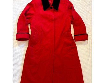 May include: A bright red long coat featuring a contrasting black collar and black trim on the sleeve cuffs. The coat has a single visible button closure at the neckline and two side pockets. The interior label displays the text ML.