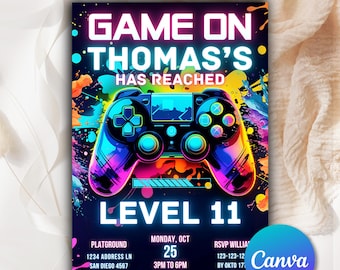 May include: A vibrant invitation with the text "GAME ON THOMAS'S HAS REACHED LEVEL 11". The design features a colorful video game controller and event details: date, time, and location. The background has a splash of colors.