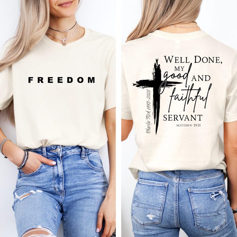 May include: A cream-coloured t-shirt with the word "FREEDOM" printed in black on the front. The back of the shirt features a black cross design with the text "Well Done, My Good and Faithful Servant" and "Matthew 25:21".