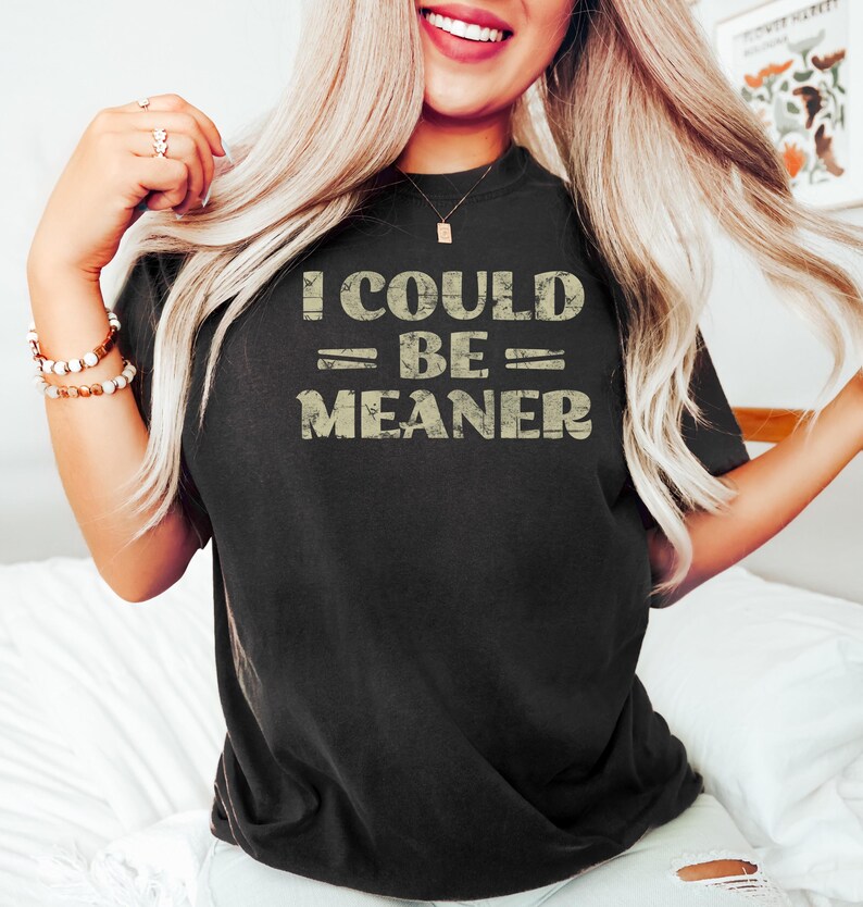 May include: A black t-shirt with a vintage-style graphic that reads "I could be meaner".