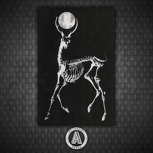May include: A black and white image of a deer skeleton with a full moon above its head. The image is on a black background and has the text "AUTONOMY PRESS" at the bottom.