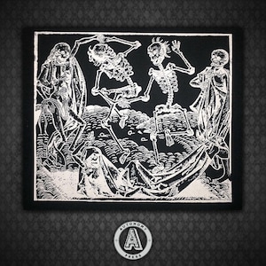 May include: Black and white embroidered patch featuring a medieval-style illustration of three skeletons dancing with a person lying on the ground. The patch has a white background and black outlines.