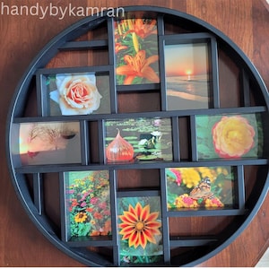 May include: A round black picture frame with 10 individual picture slots. Each slot holds a different photograph of flowers, a sunset, a lily pad, and a field of flowers.
