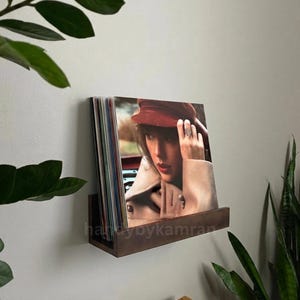 May include: A set of three ceramic vases in varying heights and shapes. The vases are glazed in a matte white finish, offering a minimalist aesthetic. The tallest vase is approximately 10 inches high.