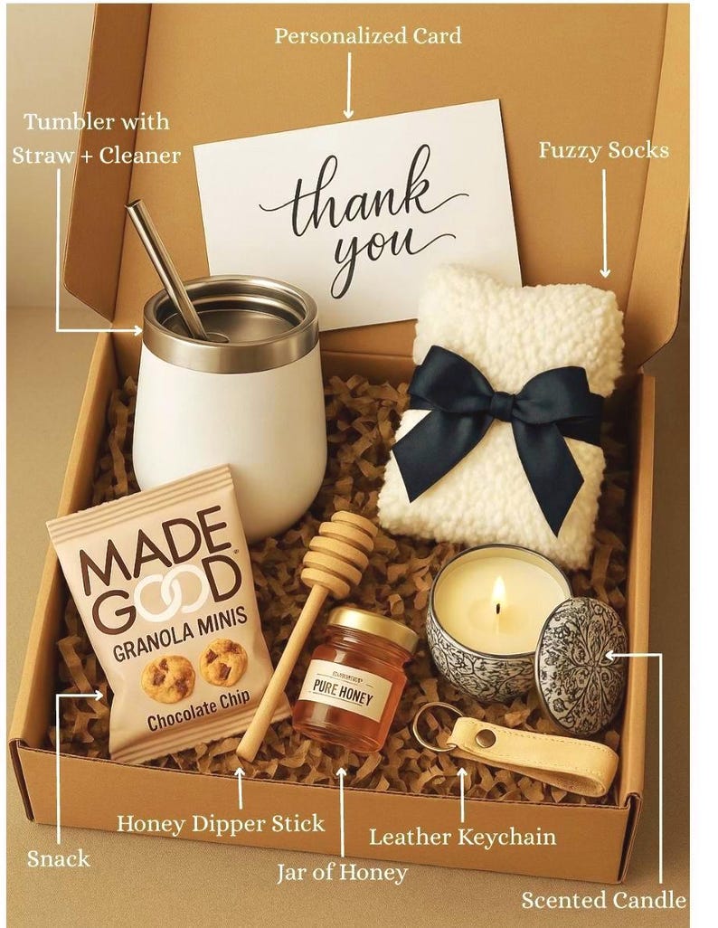 May include: A gift box filled with various items, including a white tumbler with a straw, a small bag of chocolate chip granola, a jar of honey with a honey dipper stick, a white fluffy sock with a black ribbon, a small scented candle in a blue and white ceramic container, a leather keychain, and a personalised card that says "thank you".