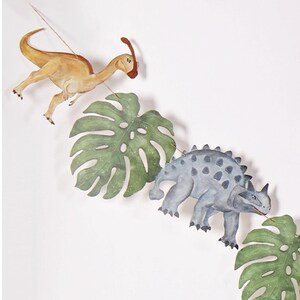 Close-up snapshot of fourth segment of Joy Ladder Dinosaurs banner featuring tree element