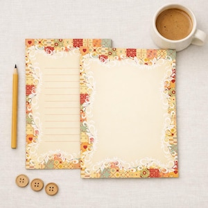 May include: Two sheets of stationery with a decorative border featuring a patchwork design in red, yellow, and green. A yellow pencil, three wooden buttons, and a cup of coffee are also present.