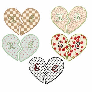May include: Five pairs of split heart-shaped ornaments featuring various patterns including tan checkerboard, floral prints in red and green, and black polka dots. Each half displays a single embroidered letter: K, A, H, B, E, or C in script.