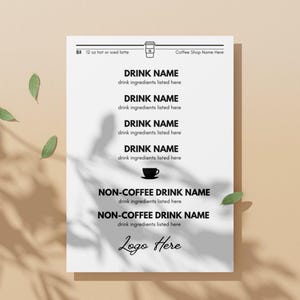 May include: A black and white printable menu template for a coffee shop. The menu lists different drink names and their ingredients. The menu also includes the price of a 12 oz hot or iced latte, which is $5. The menu also includes the text "Coffee Shop Name Here" and "Logo Here".