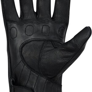 May include: Black leather motorcycle glove with padded knuckles and fingers. The glove features a wrist strap with a snap closure and quilted stitching on the palm. The fingers are pre-curved for a comfortable grip.