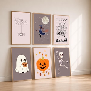 May include: Six framed wall art prints featuring Halloween themes including a spider on a web, a witch on a broomstick, text reading Eat Drink and be SCARY, a ghost holding a pumpkin, a jack-o'-lantern with autumn leaves, and a dancing skeleton.