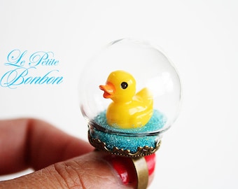 Traveling duck in a glass globe ring