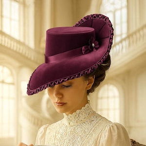 May include: A deep burgundy velvet hat with a wide brim and a decorative bow. The person in the image is wearing a vintage white dress and holding a teacup and saucer. A white teapot and scones are on the table. Includes a PDF pattern icon.