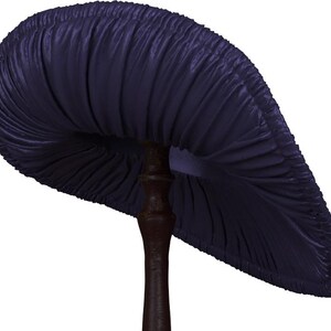 May include: A dark blue mushroom with a ruffled cap and a thick, brown stem.