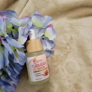 May include: A clear glass bottle with a bamboo dropper and a label that reads "Koshen Skin Beauty Turmeric VC Serum - Melanin-Inhibited Whitening - Turmeric - Brightening - 30ml/1 fl. oz."