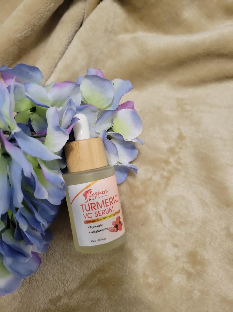 May include: A clear glass bottle with a bamboo dropper and a label that reads "Koshen Skin Beauty Turmeric VC Serum - Melanin-Inhibited Whitening - Turmeric - Brightening - 30ml/1 fl. oz."