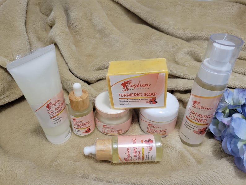 May include: A set of turmeric skincare products from Koshen, including a cleanser, serum, toner, soap, and essential oil. The products are packaged in white and yellow bottles with pink and white labels.