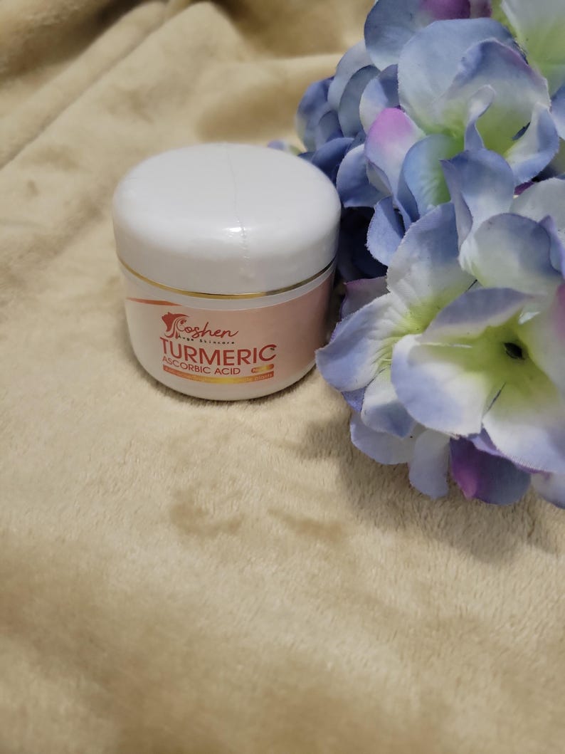May include: A white jar with a gold lid and a pink label that says "Koshen Skin Care" and "Turmeric & Ascorbic Acid".
