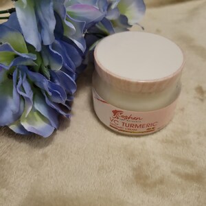 May include: A white jar with a pink lid and label. The label says "Koshen Naturals" and "VC Turmeric Organic Cream".